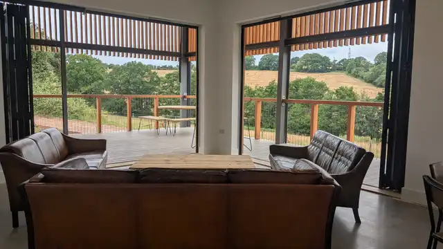 Off-grid cabin exterior with log burner chimney on the Monmouthshire rewilding project