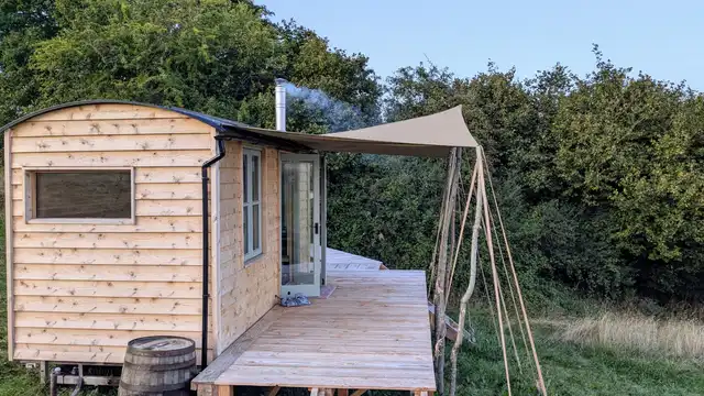 Wildflower meadow path leading to handcrafted tiny home in Monmouthshire